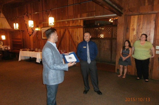 Manager of Cattlemens receiving certificate of recognition