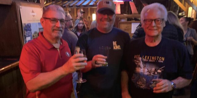 Three men toast on Veterans Day at the Cattlemens in Roseville